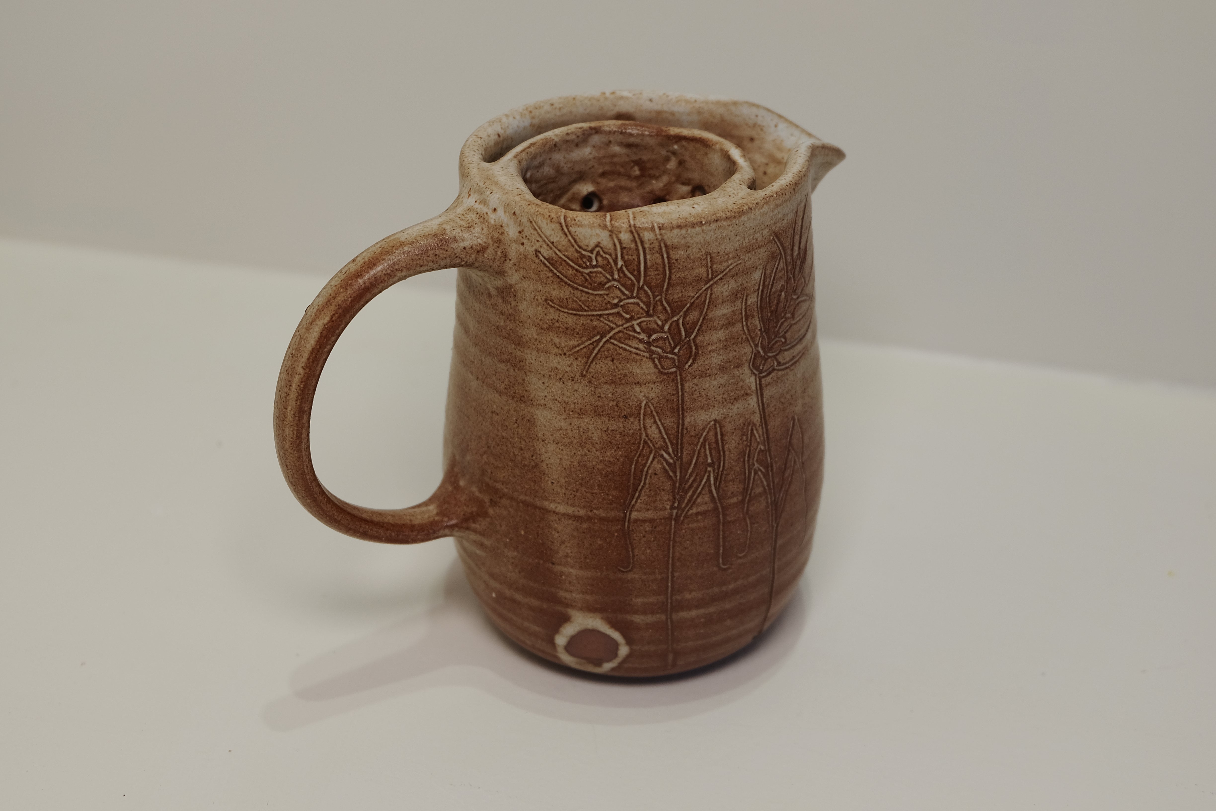 jug with tea of herb strainer