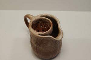 jug with tea of herb strainer