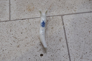 porcelain snail with cobalt fly on his back