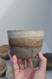 brown cup with carved lines