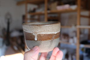 small cup with carved lines